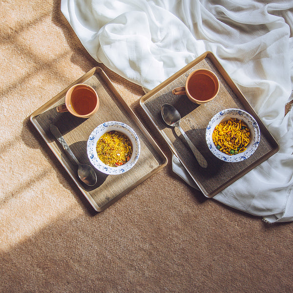 Set of three brown serving trays of different sizes on a white background